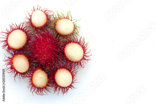 Fresh Rambutan with green leaves isolated on white background