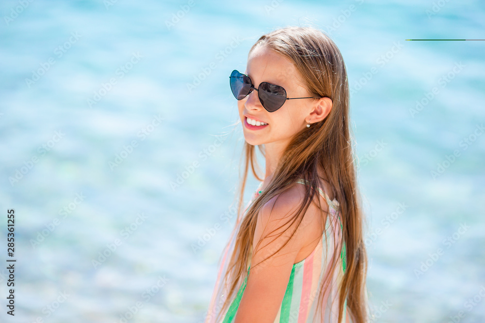 Cute little girl at beach during summer vacation Cute little girl at beach during summer vacation