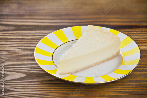 delicious cheesecake with coconut on  plate photo