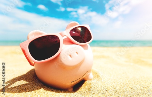 Piggy Bank Wearing Sunglasses Relaxing © BillionPhotos.com