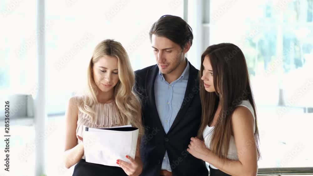 business couple signing an agreement to purchase a new car for their company business couple signing an agreement to purchase a new car for their company