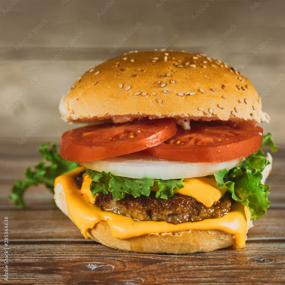 Fresh colorful homemade hamburger on wooden table. Fresh colorful homemade hamburger on wooden table.