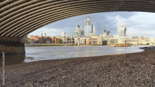 A view of London city from underneath a bridge on Thames River. photo