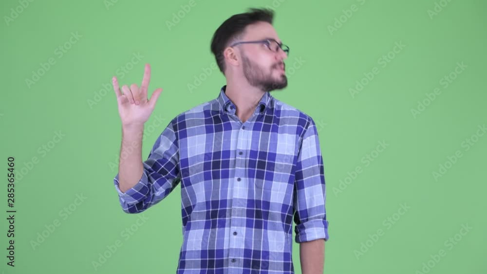 Happy young bearded hipster man with rock hand gesture Happy young bearded hipster man with rock hand gesture