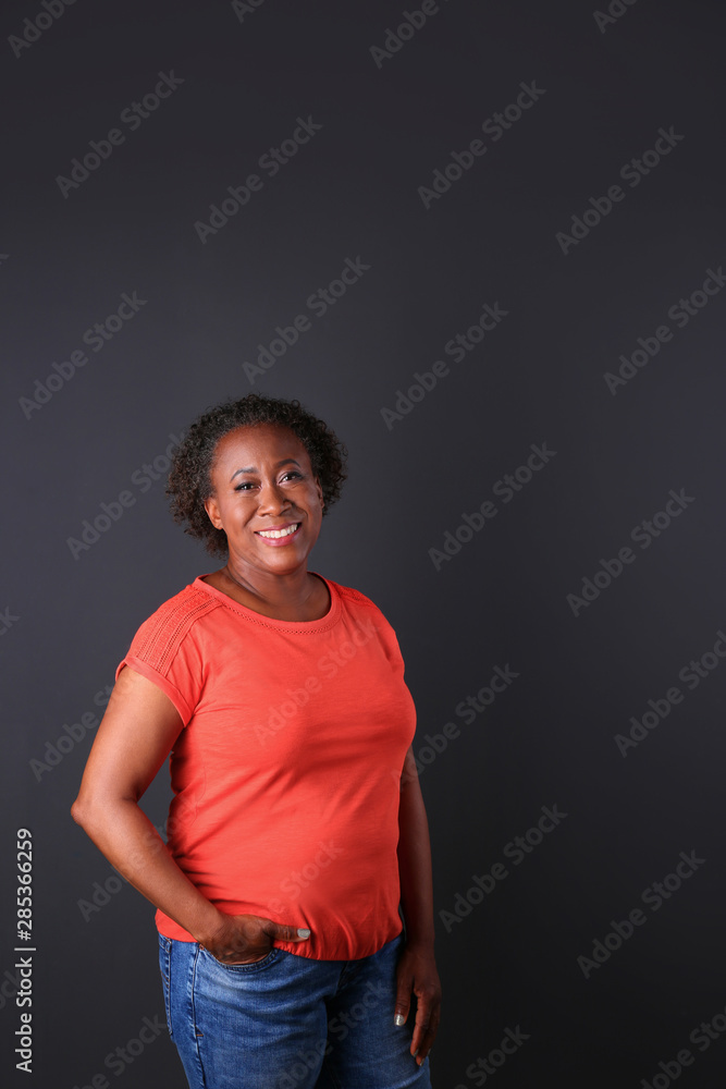 Portrait of happy African-American woman on black background Portrait of happy African-American woman on black background