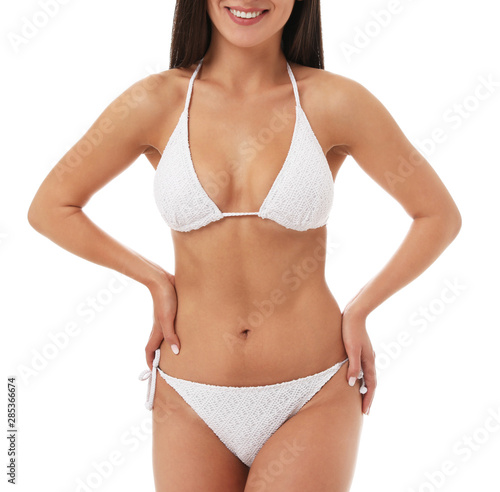 Pretty sexy woman with slim body in stylish bikini on white background, closeup view