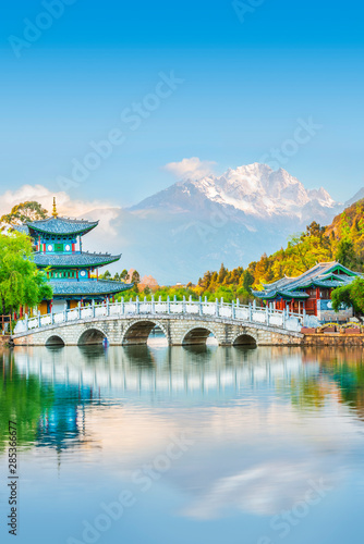 Black Dragon Pond Park. Jade Dragon Snow Mountain, chinese pavilion and bridge. Located in Lijiang, Yunnan, China.