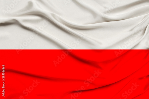 national flag of the country of Poland on gentle silk with wind folds, travel concept, immigration, politics