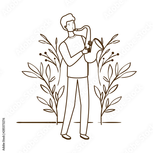 silhouette of man with saxophone and branches and leaves in the background