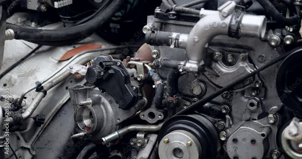 Auto mechanic working on car engine in mechanics garage. car service, repair, maintenance and people concept Auto mechanic working on car engine in mechanics garage. car service, repair, maintenance and people concept