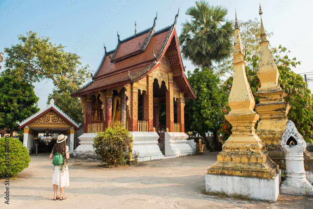 Woman visiting Wat Sensoukaram one of the most popular temple in Luang Prabang, Laos. 