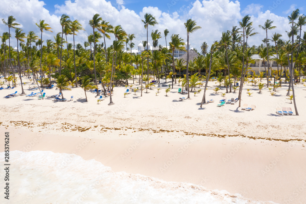 Aerial view from drone on caribbean seashore with sunbeds Aerial view from drone on caribbean seashore with sunbeds