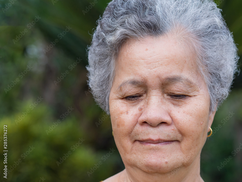 Close-up of face senior woman smiling happiness Close-up of face senior woman smiling happiness