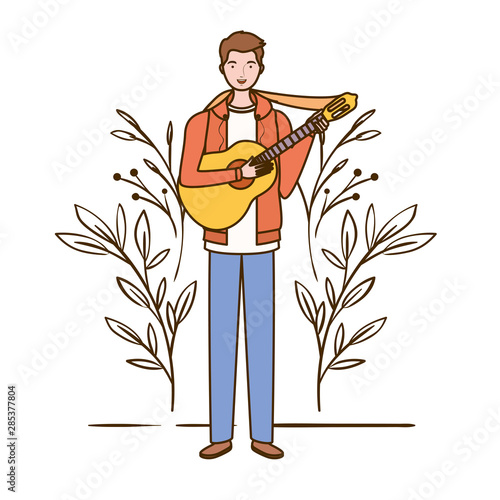 man with acoustic guitar and branches and leaves in the background photo