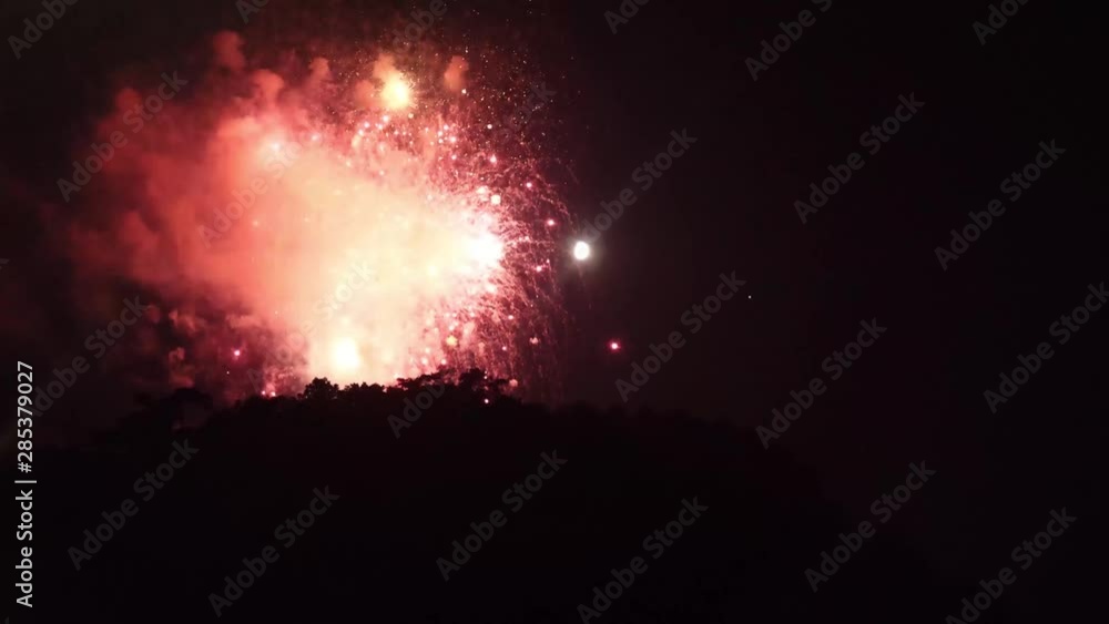 Fireworks Festival in the mountains. The fireworks were set off on top of a mountain with the moon in the background. Fireworks Festival in the mountains. The fireworks were set off on top of a mountain with the moon in the background.