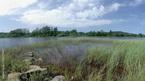 Timelapse of clouds rushing over  a river near Grimstad, Norway in late summer photo