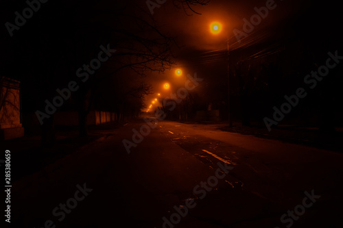 Old street at night illuminated by the lanterns © ihorbondarenko