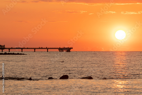 fantastic sea side view to the pier of Heiligenhafen at sunset 