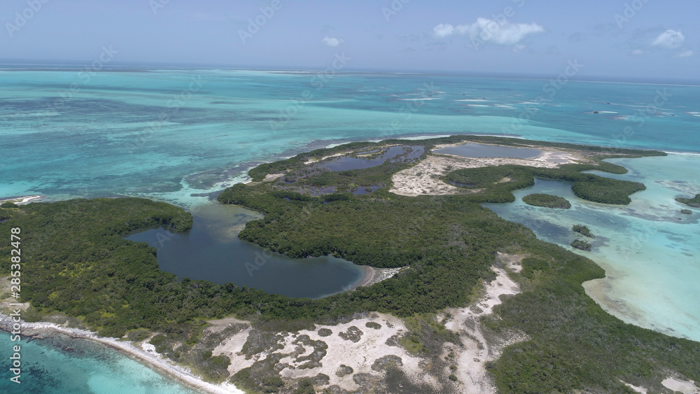 Caribbean: Vacation in the blue sea and deserted islands. Aerial view of a blue sea with crystal water. Great landscape. Beach scene. Aerial View Island Landscape Los Roques Caribbean: Vacation in the blue sea and deserted islands. Aerial view of a blue sea with crystal water. Great landscape. Beach scene. Aerial View Island Landscape Los Roques