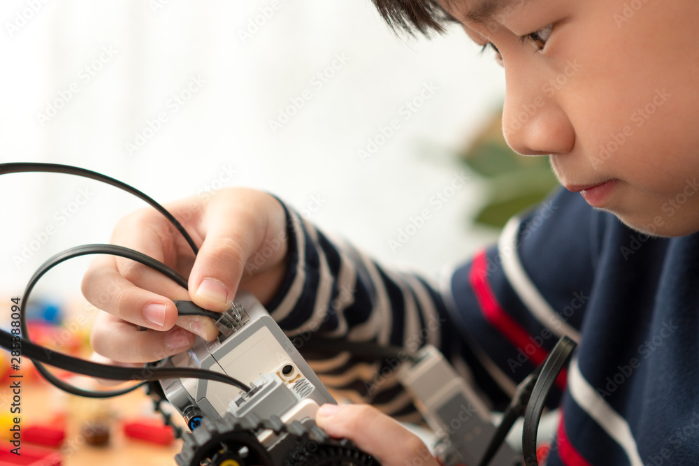 Closeup: Smart looking preteen / teenage Asian boy assembles Lego  Mindstorms EV3 for school project with focus and concentration. STEM  Education, Programming, Robotics Technology, Online Learning. Stock Photo |  Adobe Stock