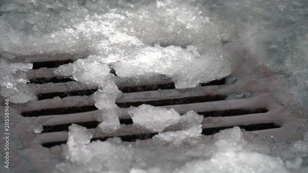 Storm Drain Snow Slush 4K UHD. A storm drain collecting water from rain