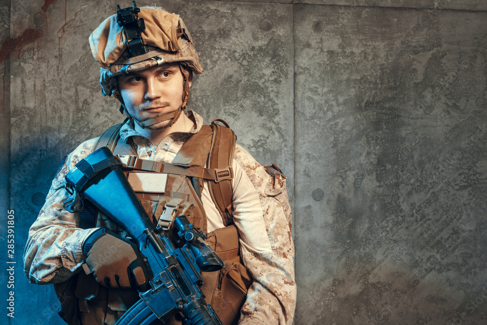fully equipped army soldier in camo uniform and helmet, armed with pistol and assault service rifle fully equipped army soldier in camo uniform and helmet, armed with pistol and assault service rifle