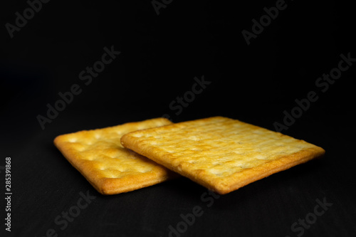 Cracker cookies on dark background.