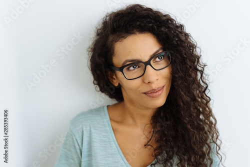 Thoughtful young woman wearing glasses