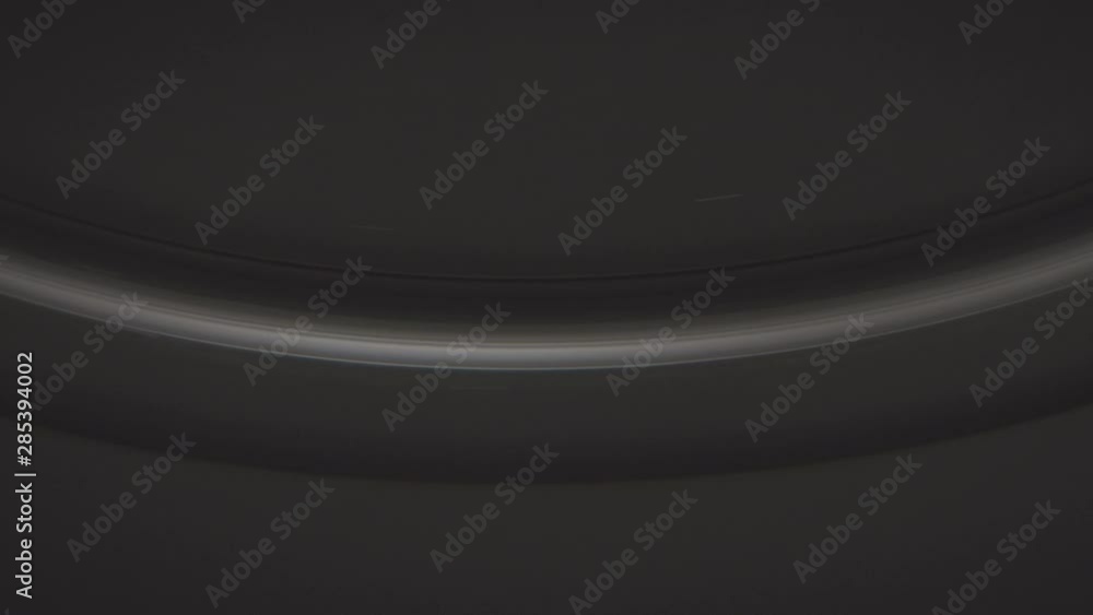 a white spherical shape shining in the dark. macro shot of an abstract glossy semicircle shining in pure darkness. commercial detail shot of an edge. a white spherical shape shining in the dark. macro shot of an abstract glossy semicircle shining in pure darkness. commercial detail shot of an edge.