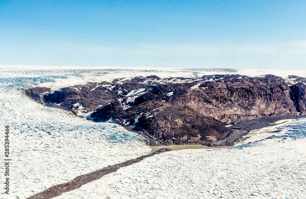 Obraz premium Greenlandic melting ice sheet glacier aerial view from the plane, near Kangerlussuaq, Greenland