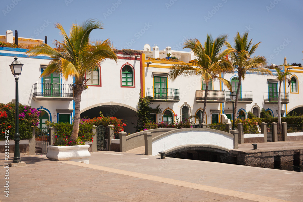 Fototapeta premium Gran Canaria, Spain - Typical architecture of Puerto de Mogan, a small fishing port of Gran Canaria. Colorfull flowers blooming around houses.