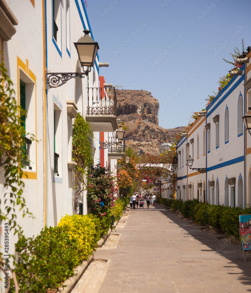 Gran Canaria, Spain - Typical architecture of Puerto de Mogan, a small fishing port of Gran Canaria. Colorfull flowers blooming around houses.