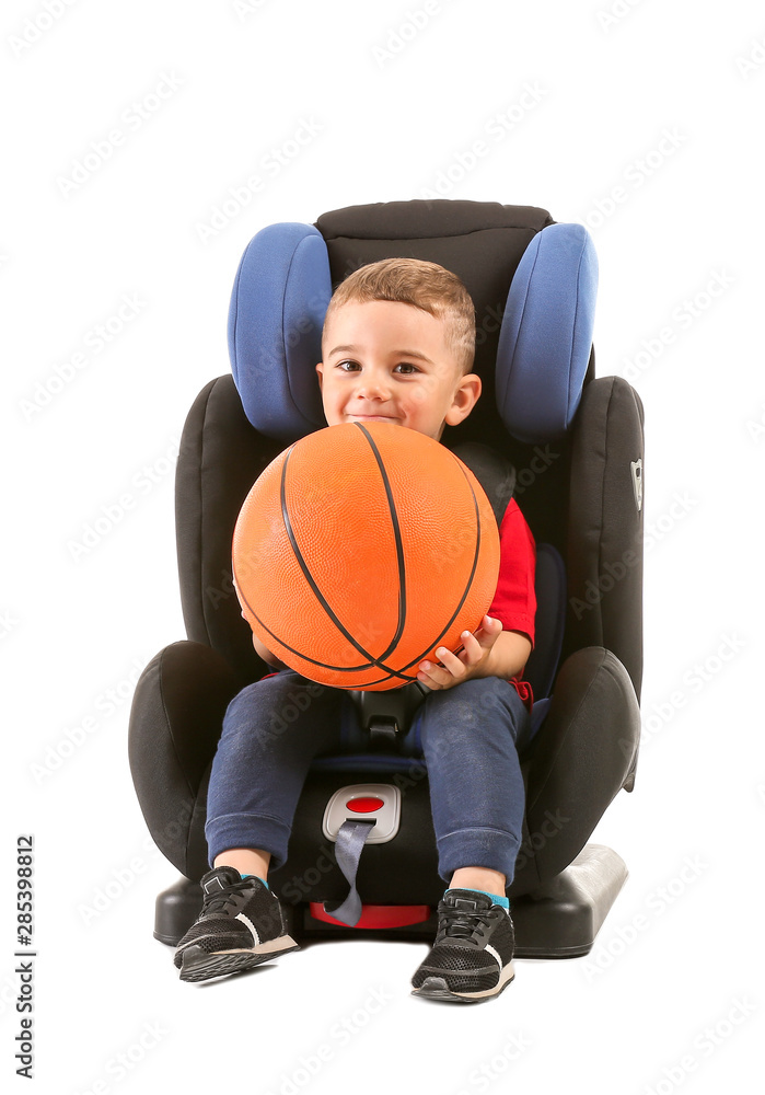 Little boy with ball buckled in car seat on white background Little boy with ball buckled in car seat on white background