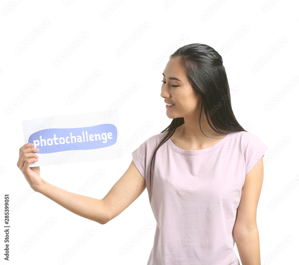 Female Asian blogger holding paper with text PHOTOCHALLENGE on white background Female Asian blogger holding paper with text PHOTOCHALLENGE on white background