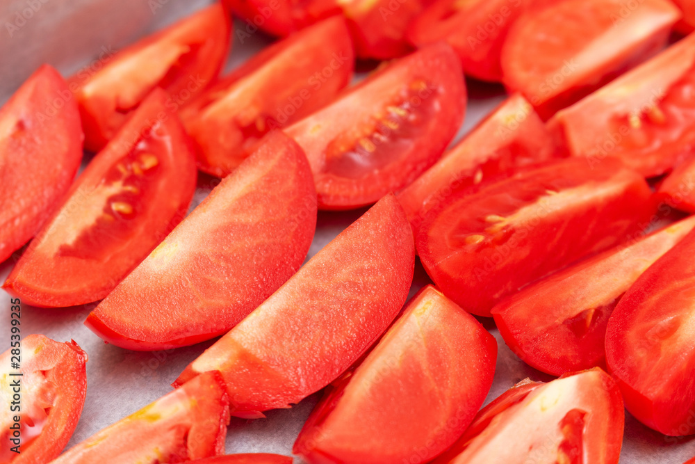 Homemade dried red tomatoes slices with basil oregano spices cooking process. Traditional Italian Mediterranean kitchen cuisine. Homemade dried red tomatoes slices with basil oregano spices cooking process. Traditional Italian Mediterranean kitchen cuisine.