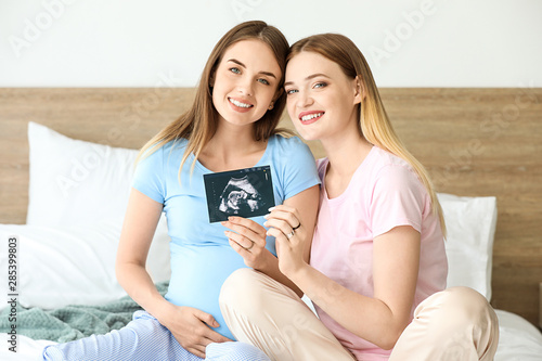 Pregnant lesbian couple wit...