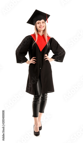 Young female student in bachelor robe on white background