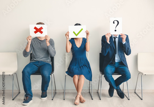 Young people holding paper ...