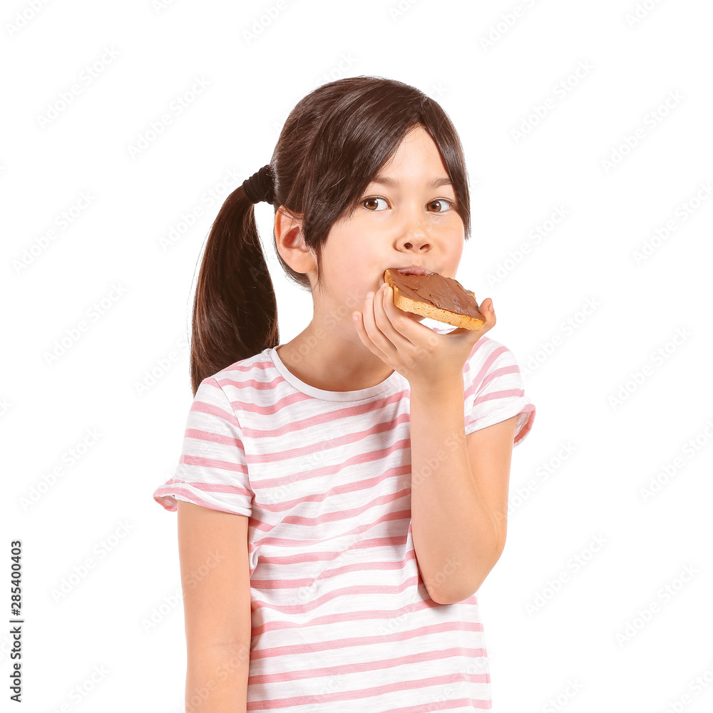 Funny little girl eating tasty toast on white background Funny little girl eating tasty toast on white background