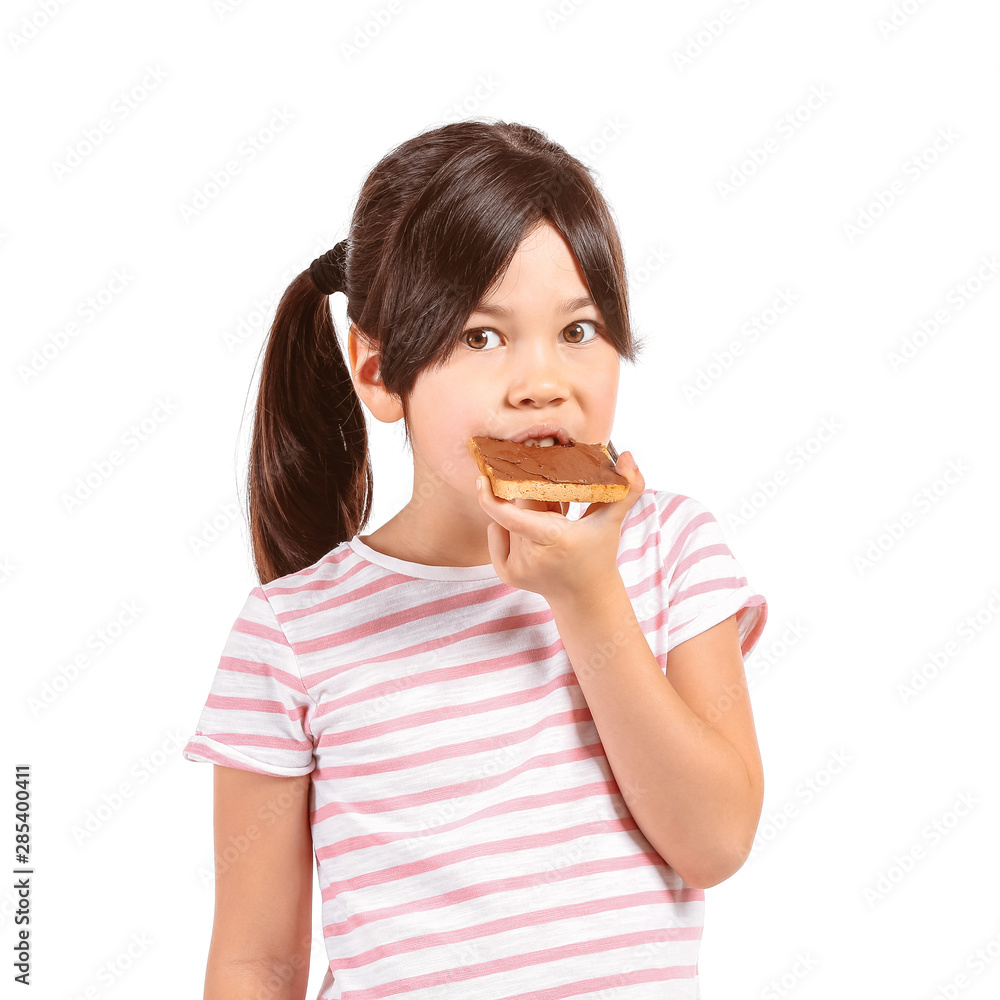 Funny little girl eating tasty toast on white background Funny little girl eating tasty toast on white background