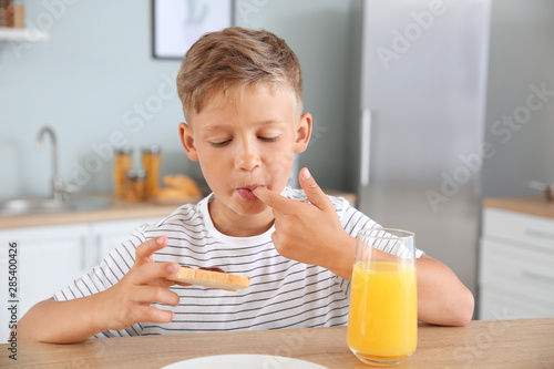 Funny little boy eating tas...