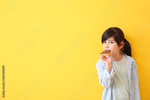Funny little girl eating ta...