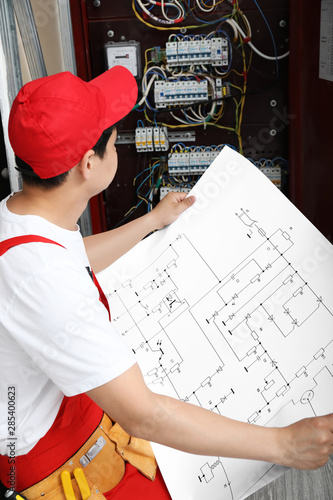 Electrician with wiring dia...