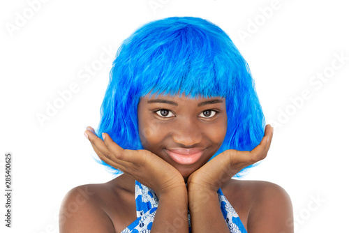 Portrait of a smiling girl playing with a blue wig, isolated, white background