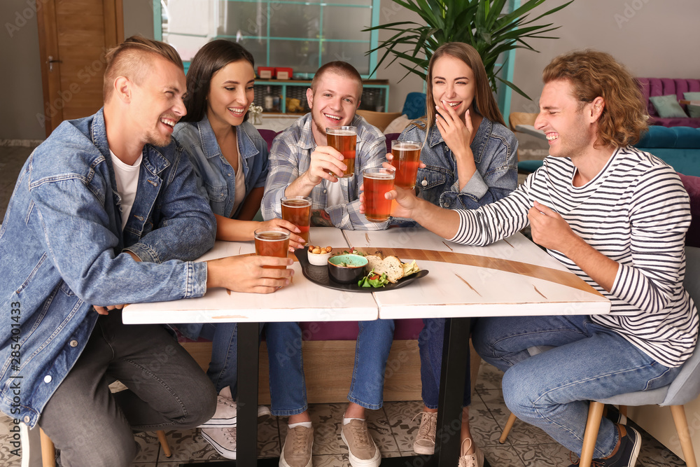 Friends drinking fresh beer in pub Friends drinking fresh beer in pub