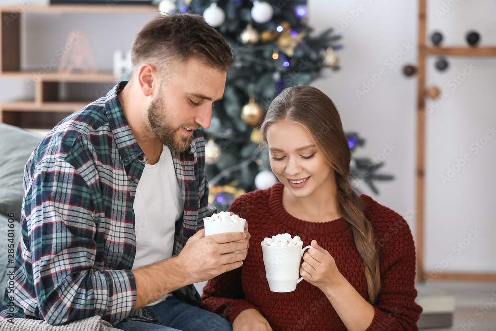 Young couple drinking hot chocolate at home