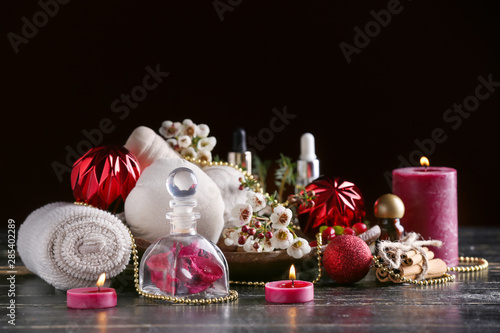 Christmas composition with products for spa treatment on dark background