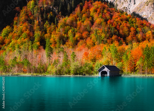 Fototapeta autumn landscape with lake and boathouse