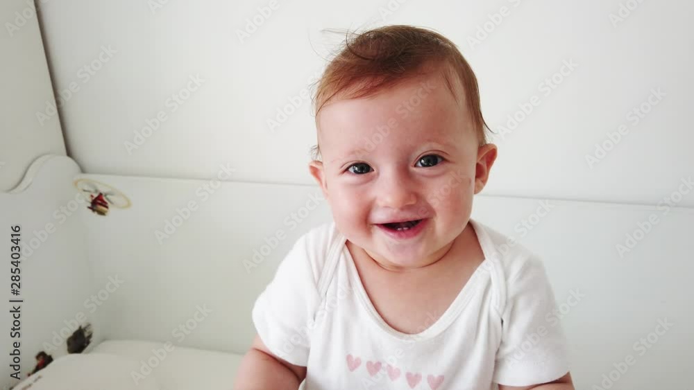 Cute baby laughing and having fun, standing in crib. Happy baby. Baby emotions. Baby smile. Cute baby laughing and having fun, standing in crib. Happy baby. Baby emotions. Baby smile.
