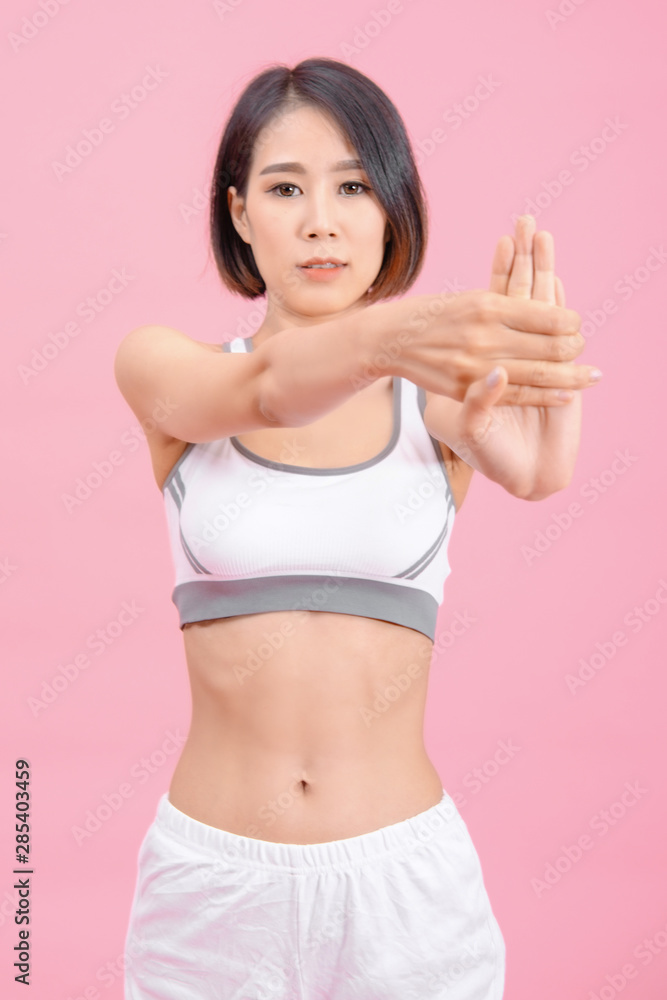 sport woman standing warm-up and stretch body before doing exercise on pink backgrounds, fitness concept, sport concept sport woman standing warm-up and stretch body before doing exercise on pink backgrounds, fitness concept, sport concept